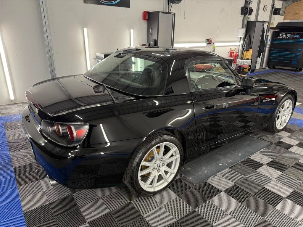 Black Honda S2000 rear quarter with a wet-look finish