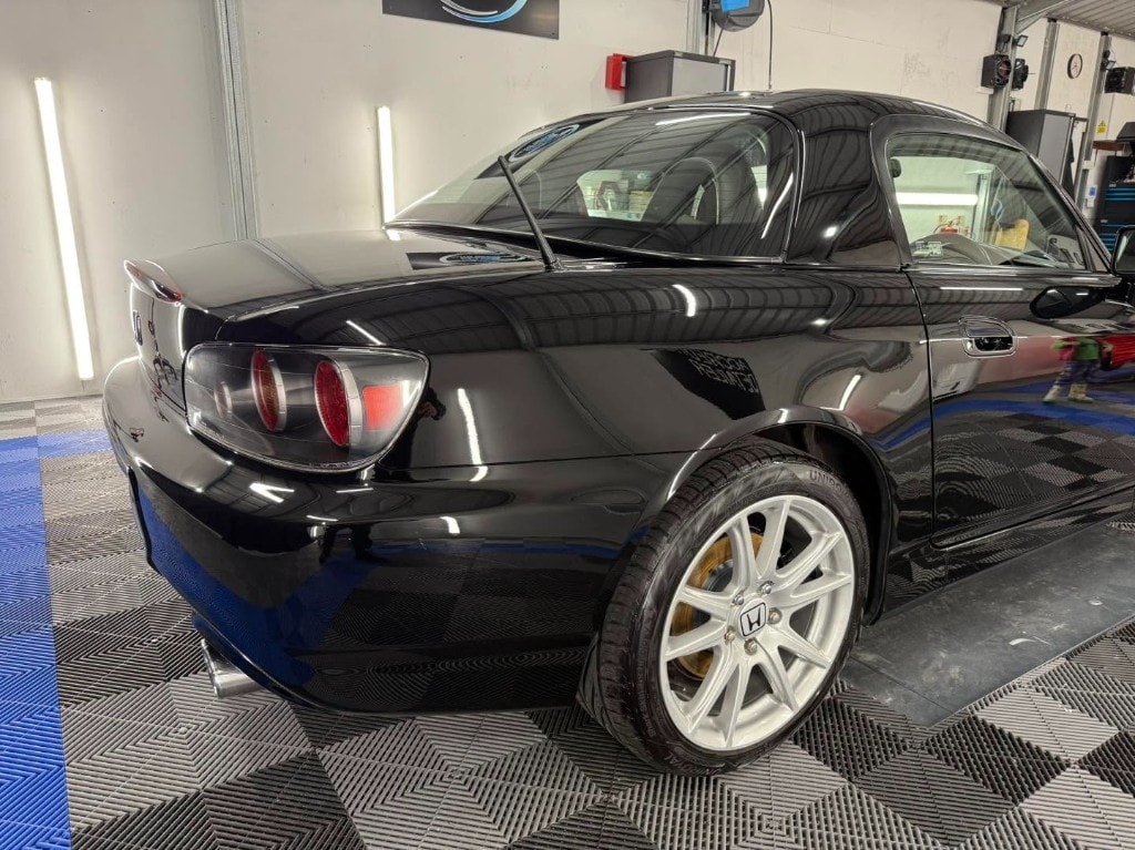 Black Honda S2000 rear quarter with a wet-look gloss
