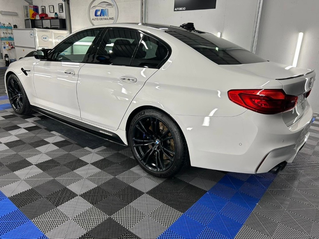 White BMW M5 rear quarter after a paint correction