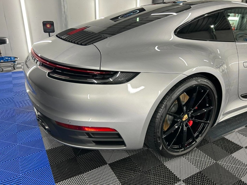 Silver Porsche 911 rear quarter and gloss-black wheel