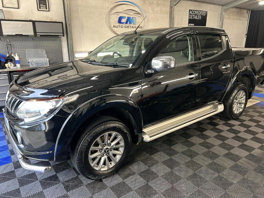 Clean, glossy black Mitsubishi L200 pickup after detailing